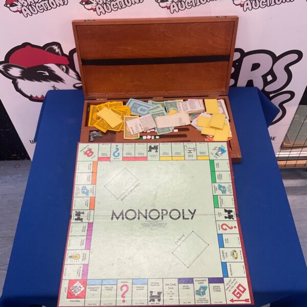 Vintage Monopoly board game in wooden case, classic collectible.