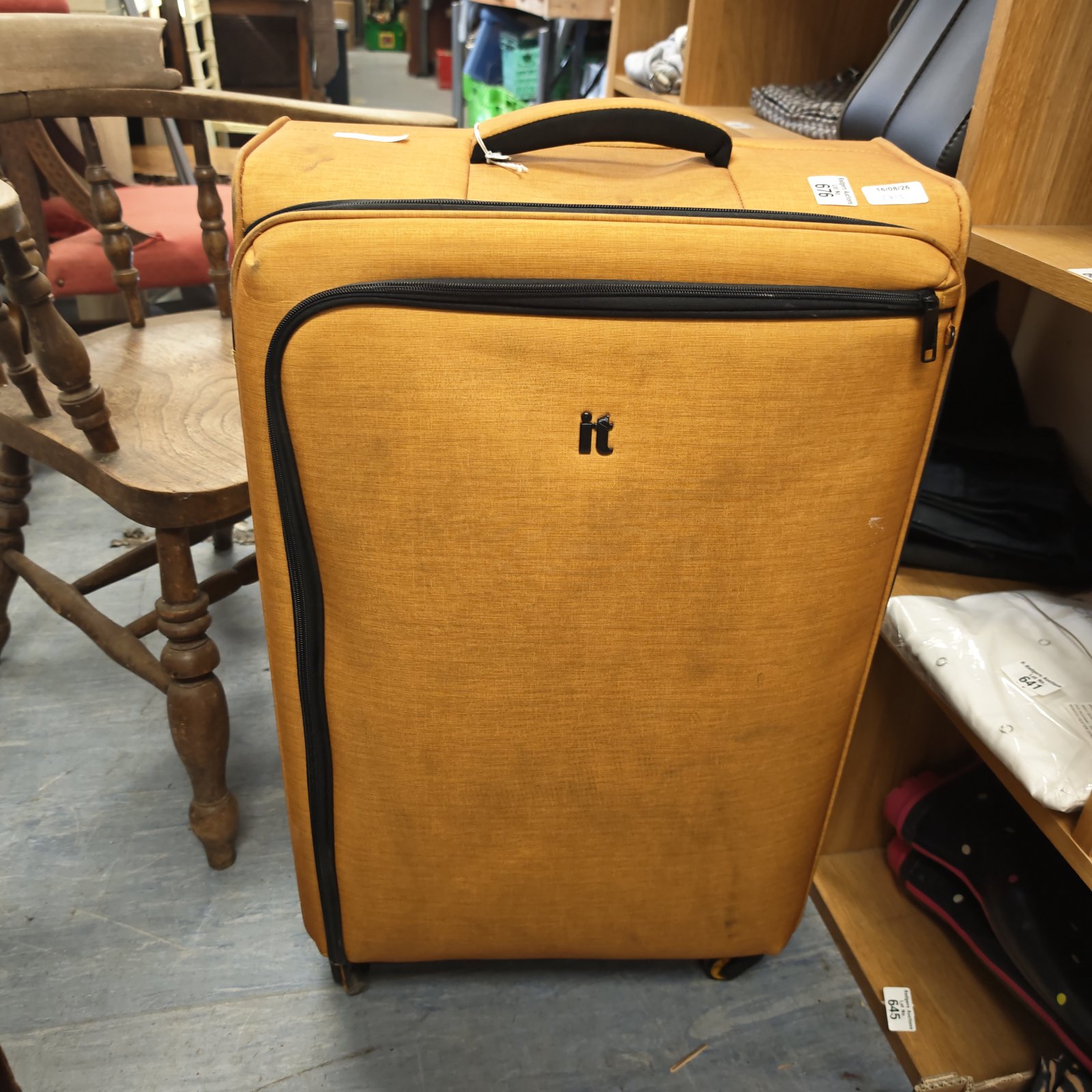 Vintage mustard coloured wheeled suitcase with extending handle.