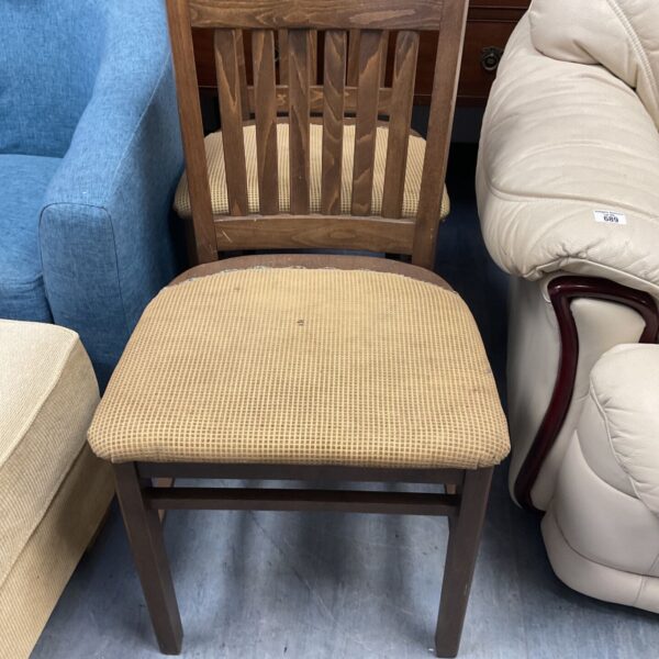 Pair of vintage oak chairs with shaped backs and contoured seats.