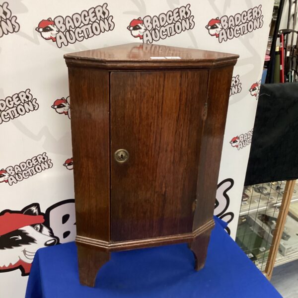 Vintage oak corner cabinet with classic design and warm wood tones.