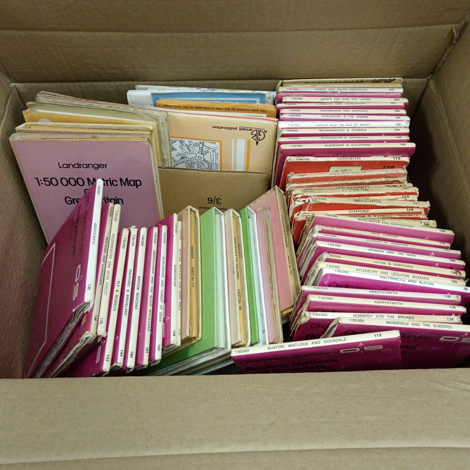 Large collection of vintage Ordnance Survey maps showing detailed British topography.