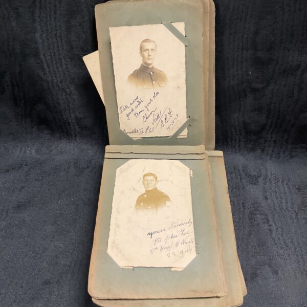 Vintage photo album with military and family photos inside.