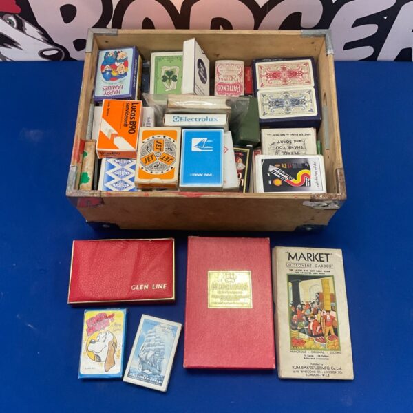 Assorted vintage playing cards in a box, collectible card game.