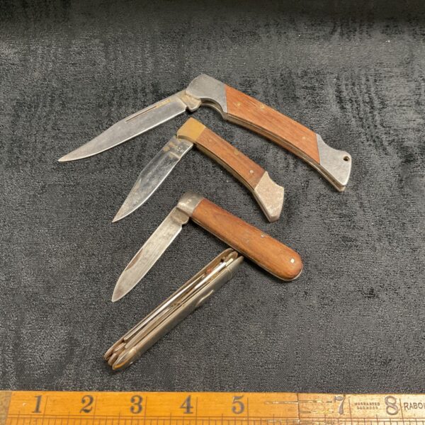 Vintage pocket knife lot with bone handles and folding blades.