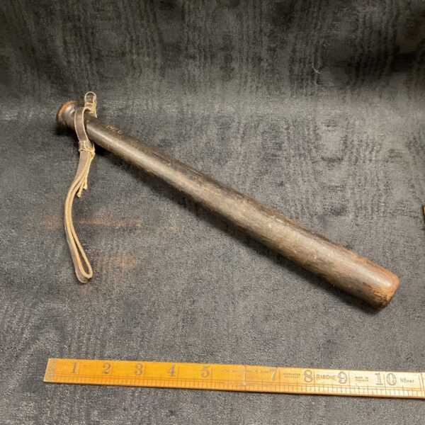 Vintage 1926 police truncheon with leather strap, collectible law enforcement baton.