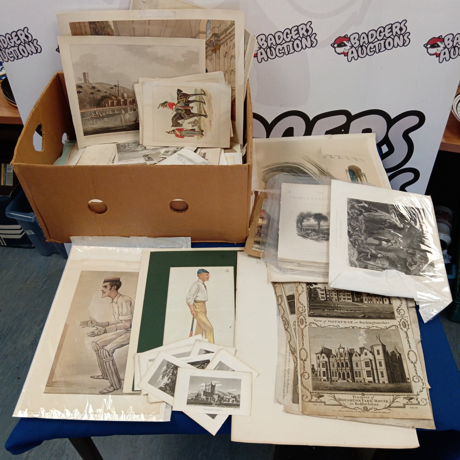 Large collection of vintage prints and antique engravings on display.