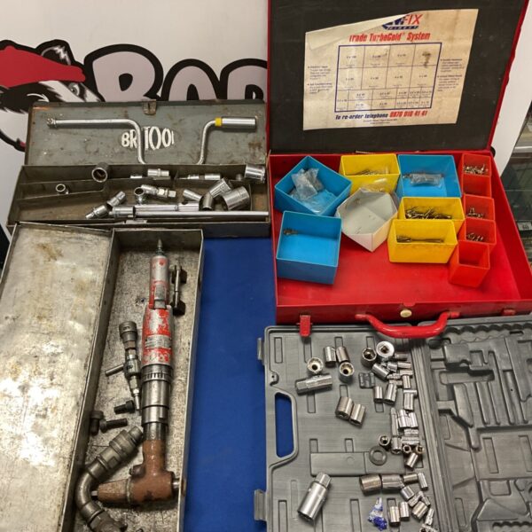 Vintage pneumatic right angle air tool with workshop tools.
