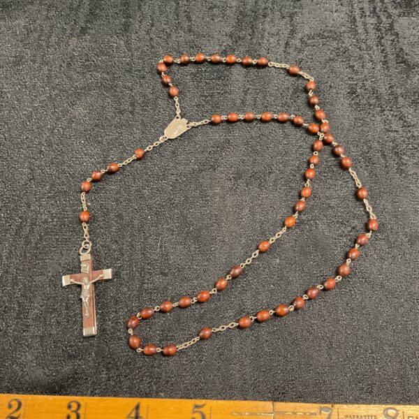 Vintage rosary necklace with crucifix and brown beads.