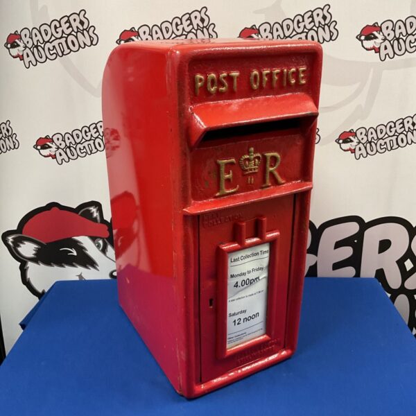 Vintage cast iron royal mail post box with ER emblem.