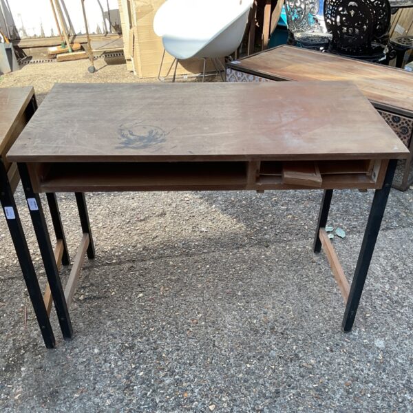 Vintage school desk with wooden top and metal legs.