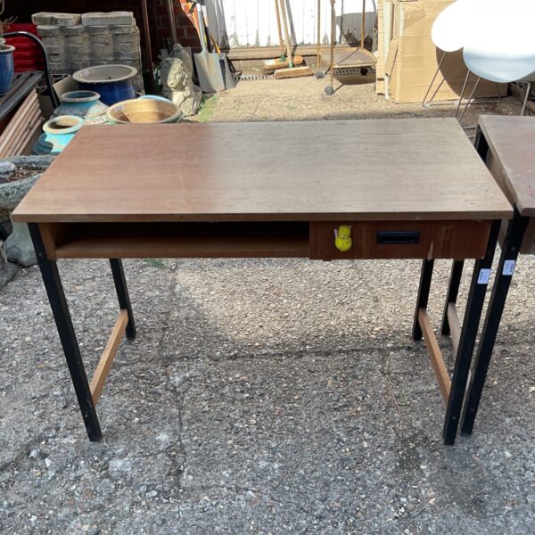 Vintage wooden school desk with storage compartment.
