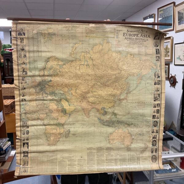 Large vintage school map scroll showing world geography.