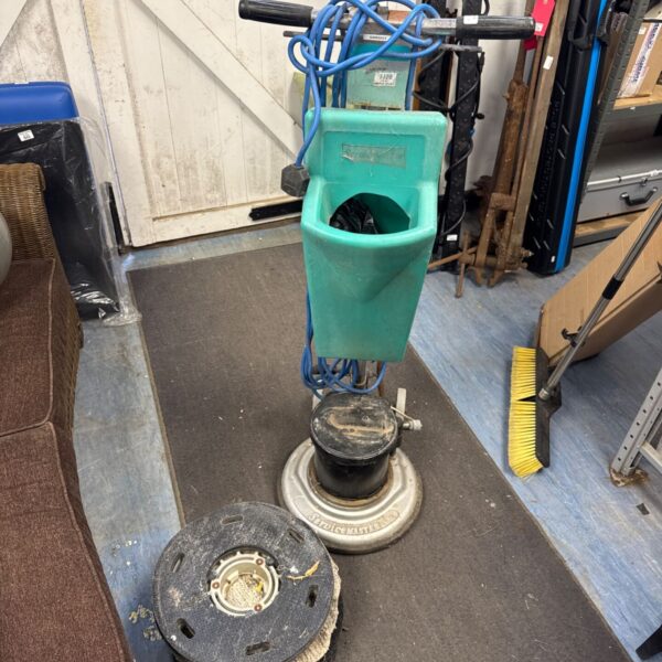 Vintage Servicemaster floor polisher with spare pads, industrial cleaning machine.