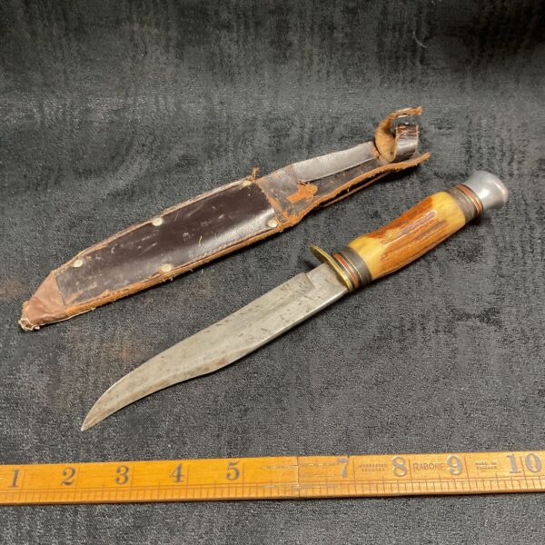Vintage Sheffield knife with horn handle and leather sheath.