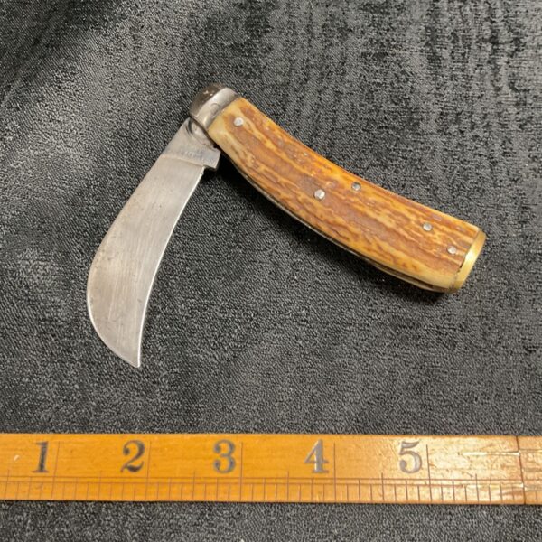 Vintage Sheffield pruning knife with open blade and horn handle.