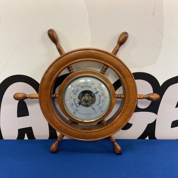 Vintage ships wheel barometer with nautical design and weather prediction dial.
