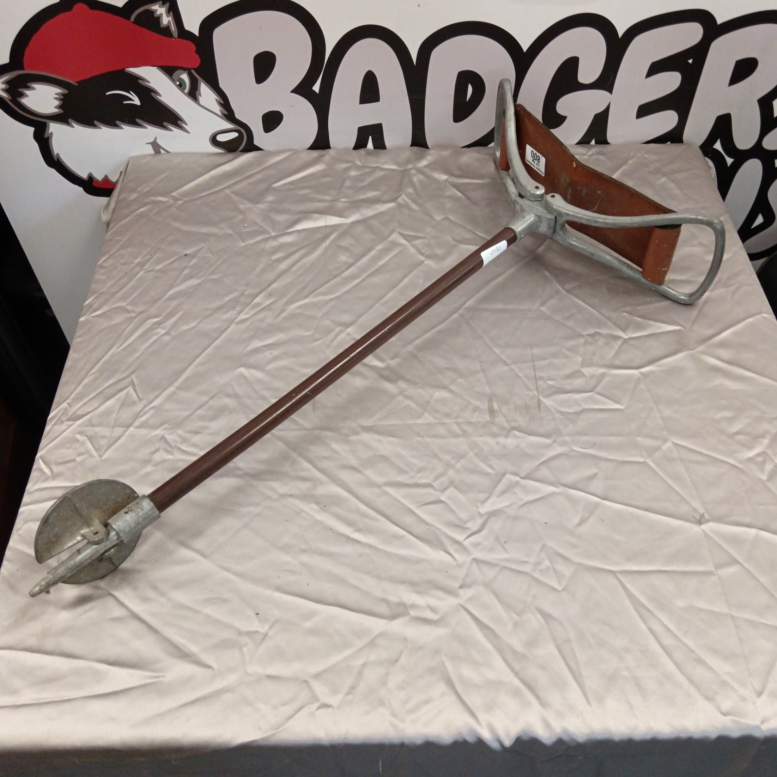 Vintage shooting stick with worn leather seat for hunting.