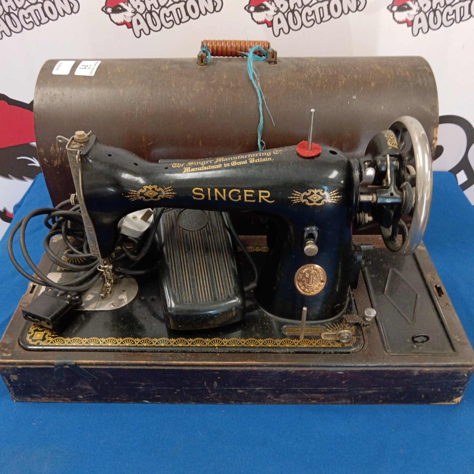 Vintage electric Singer sewing machine in used condition.