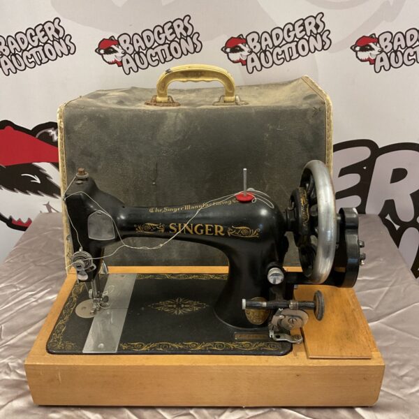 Vintage Singer sewing machine with hand crank, a collectible antique.