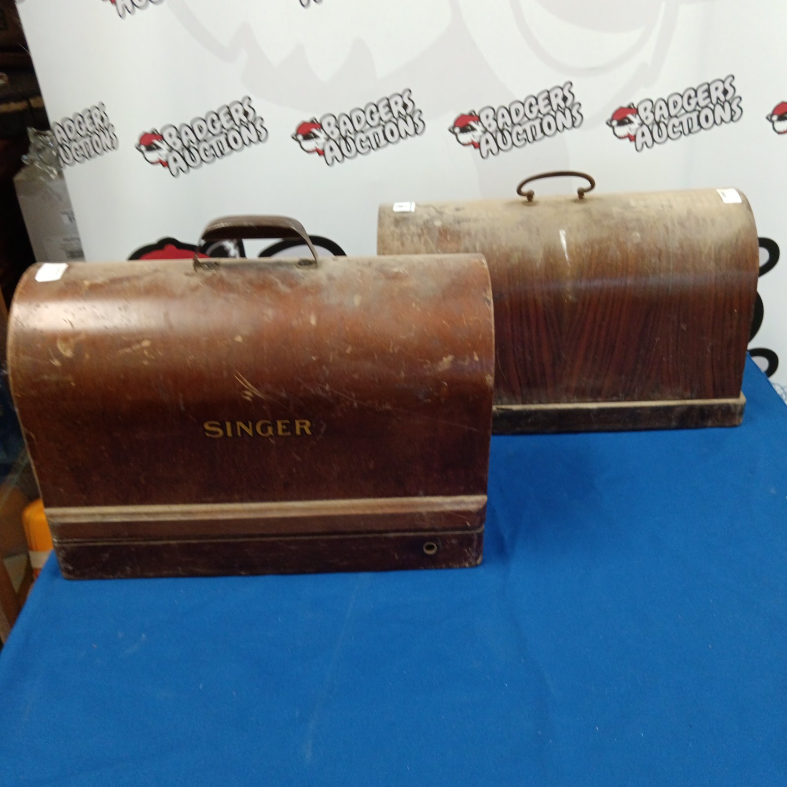 Vintage Singer sewing machines in locked wooden cases.