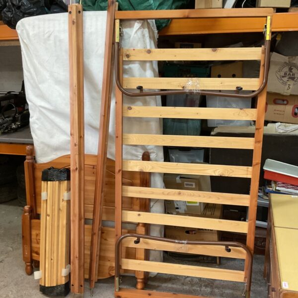 Dismantled vintage wooden single bed frame, showing slats.