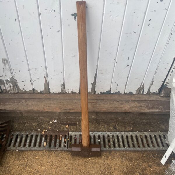 Vintage sledgehammer with wooden handle and steel head.