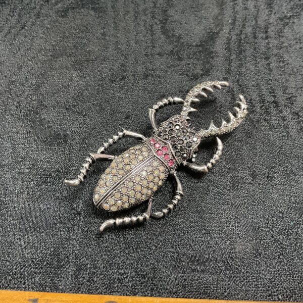 Close-up of vintage stag beetle brooch with rhinestones.