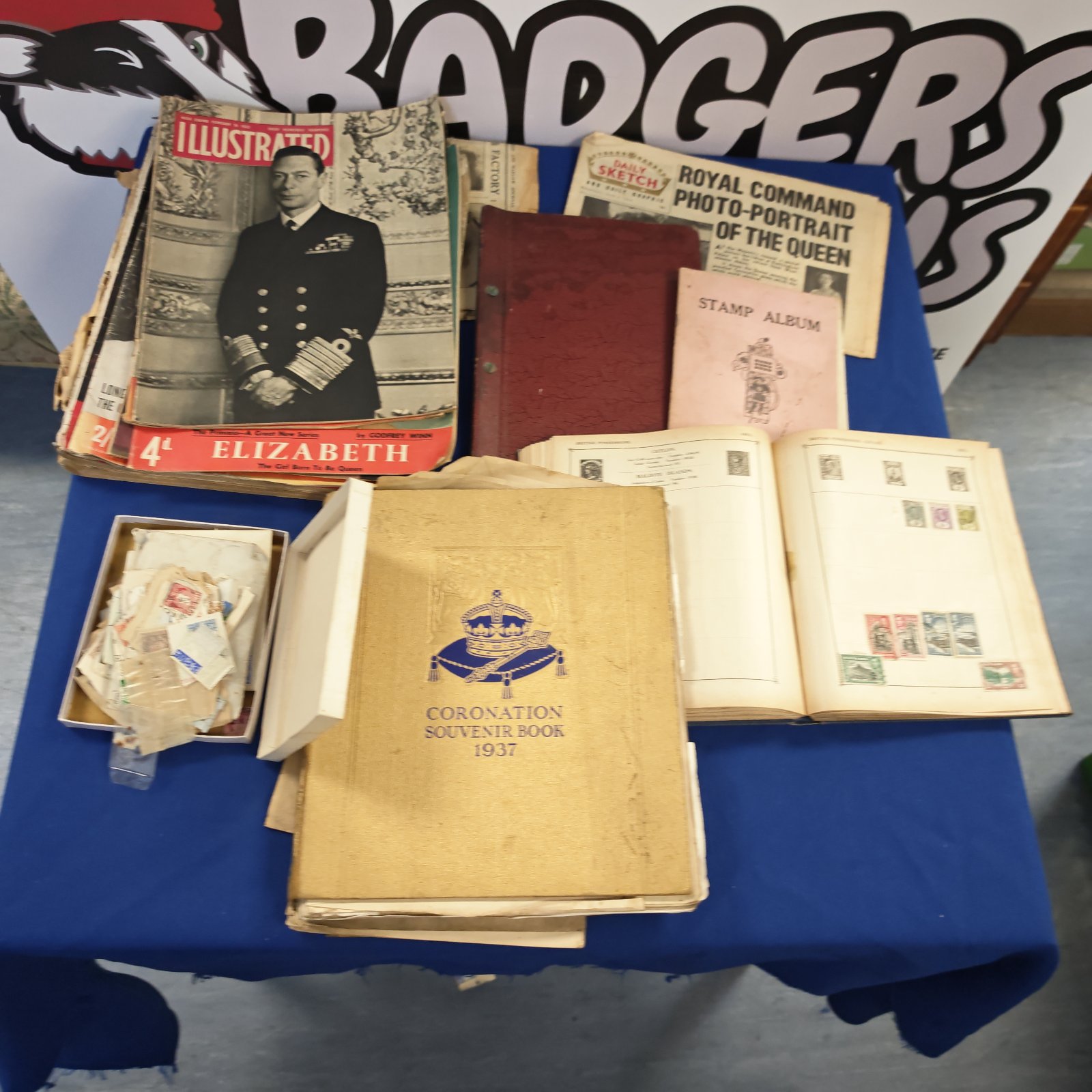 Vintage lot of stamps, newspapers, and albums for collectors.