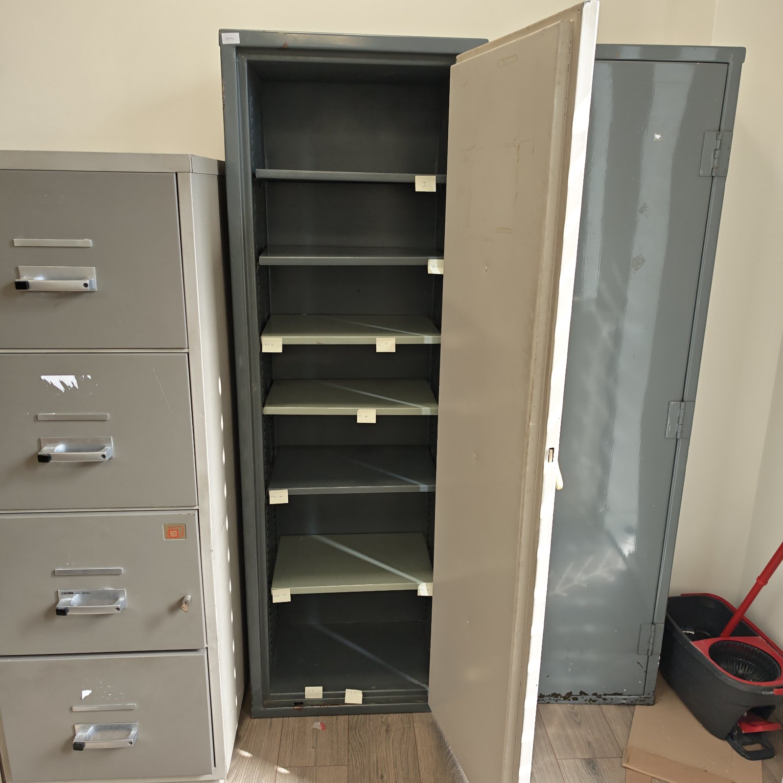 Vintage steel filing cabinet with multiple drawers for office storage.