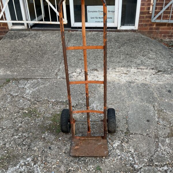 Worn vintage steel hand truck for moving heavy loads.