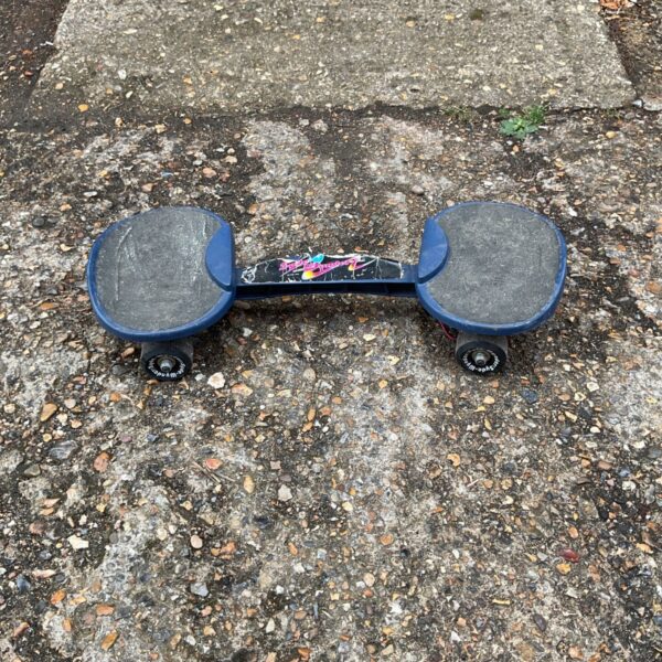 Vintage Sydewynder snakeboard with colourful graphics.