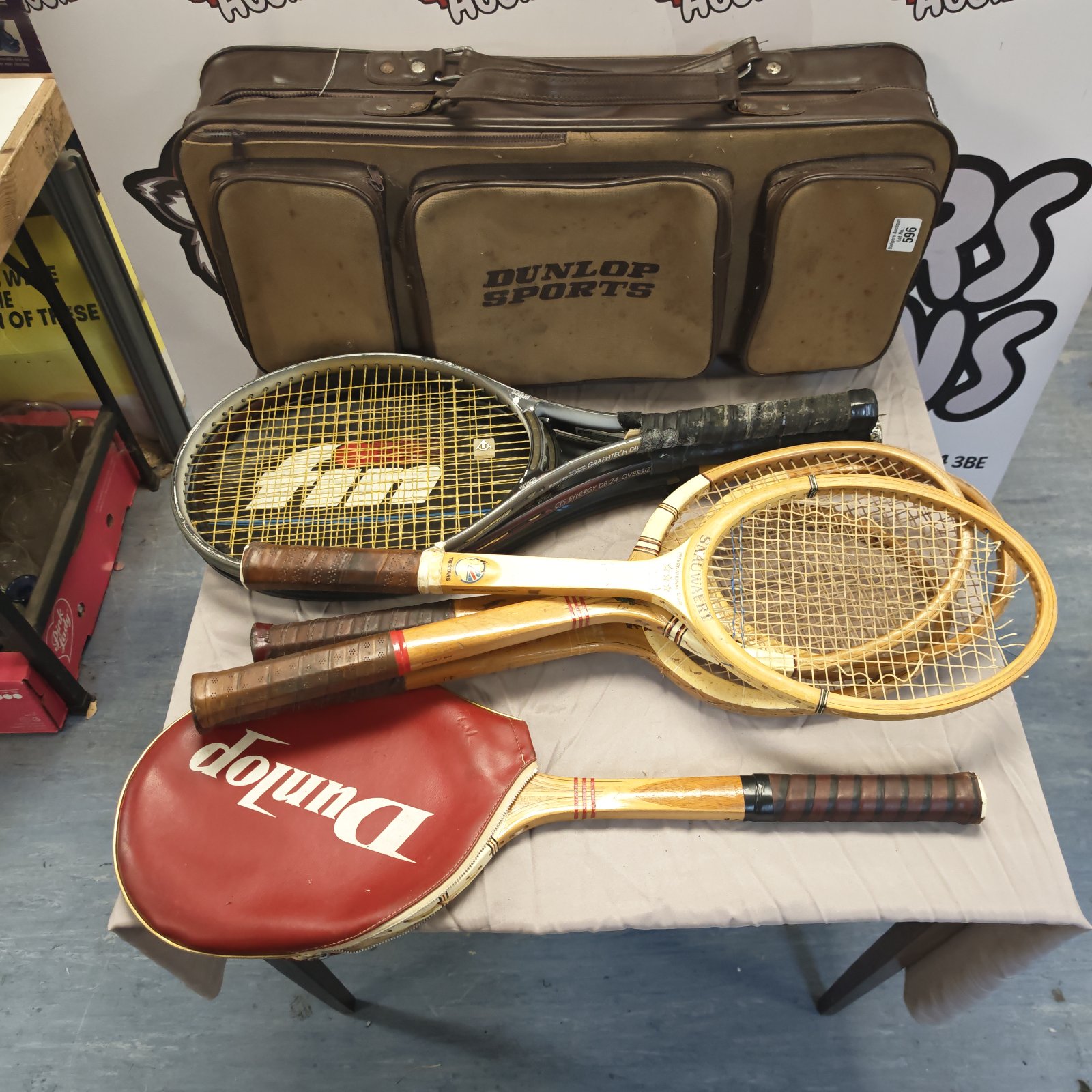 Vintage Dunlop sports bag with assorted tennis rackets inside.