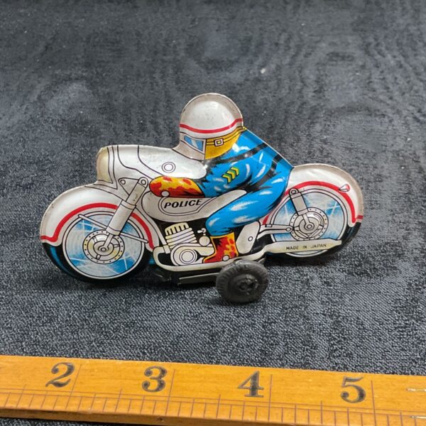 Vintage tinplate police motorcycle made in Japan, collectible toy.