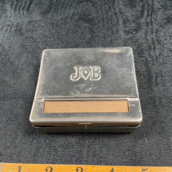 Vintage J.B. tobacco tin, a collectible metal container.