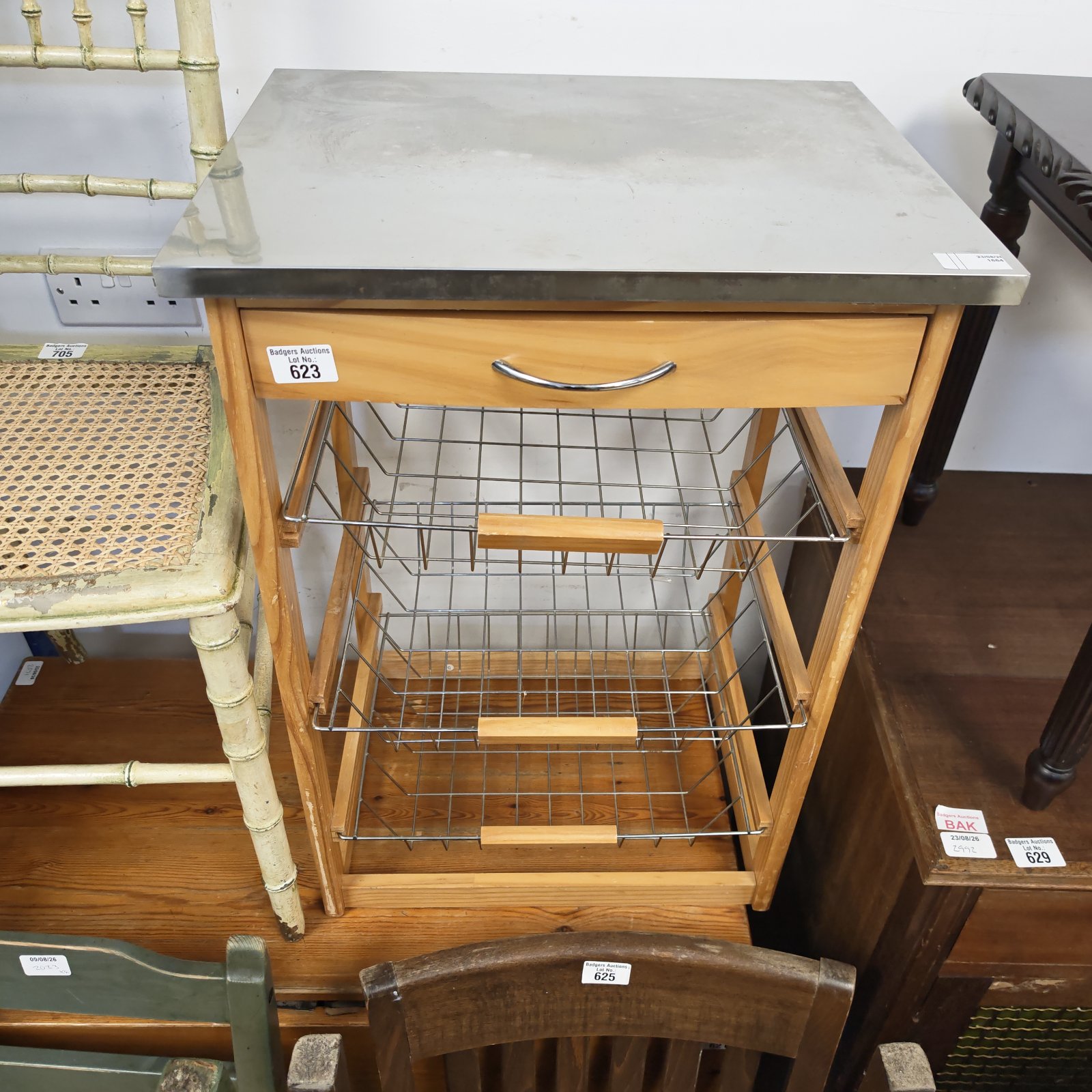 Vintage vegetable rack with stainless steel baskets for kitchen storage.
