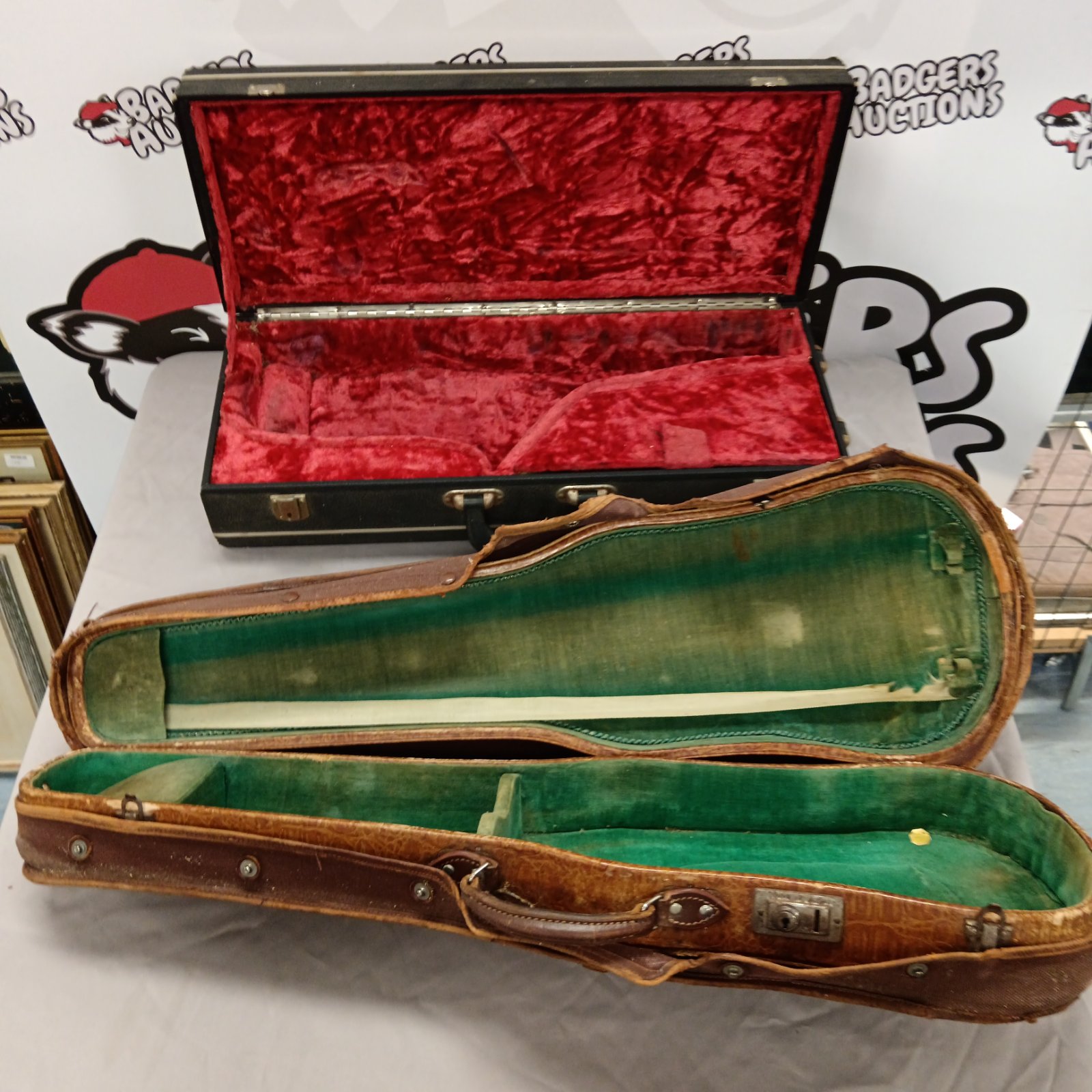Open vintage violin case with burgundy velvet lining.