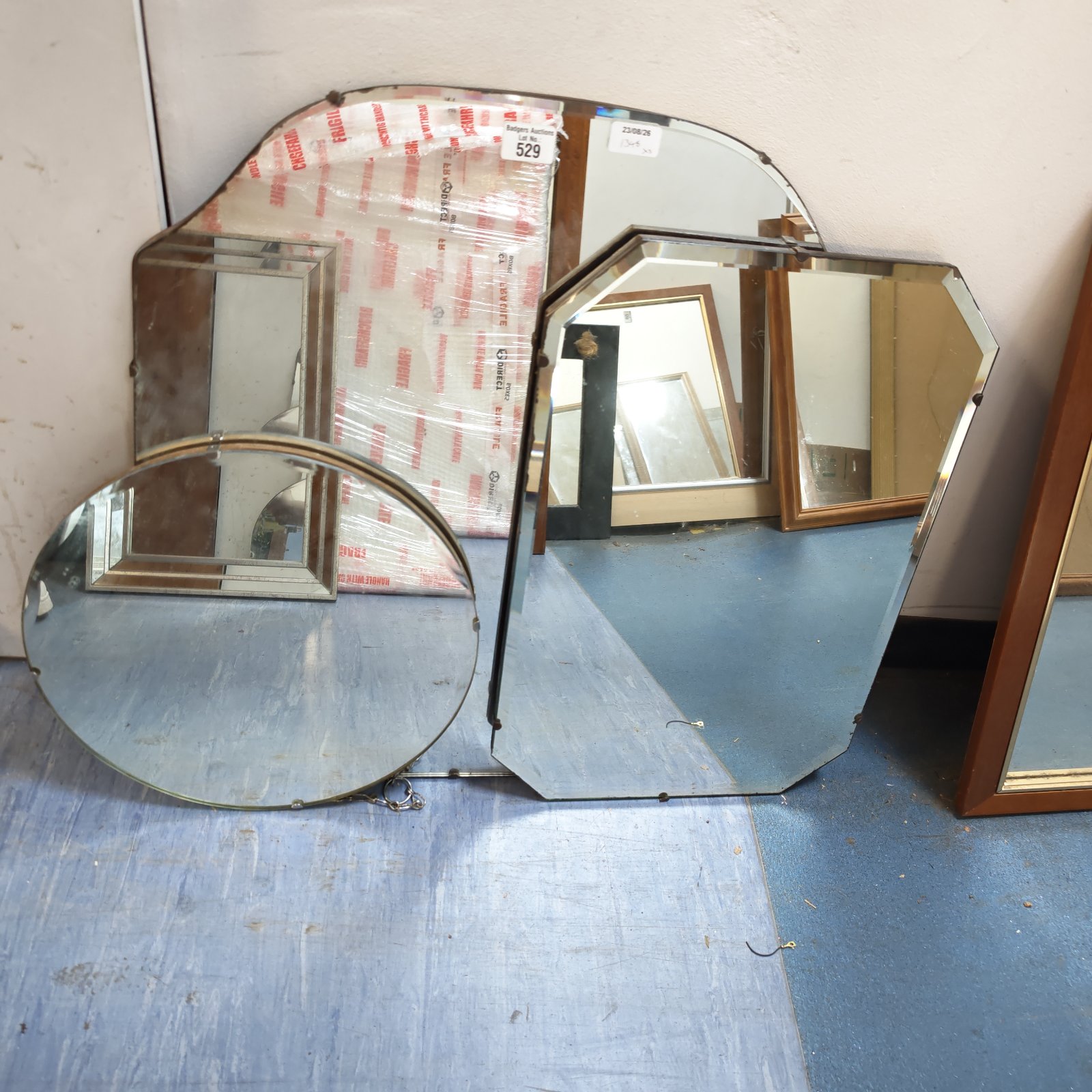 Lot of three vintage wall mirrors with unique shapes.