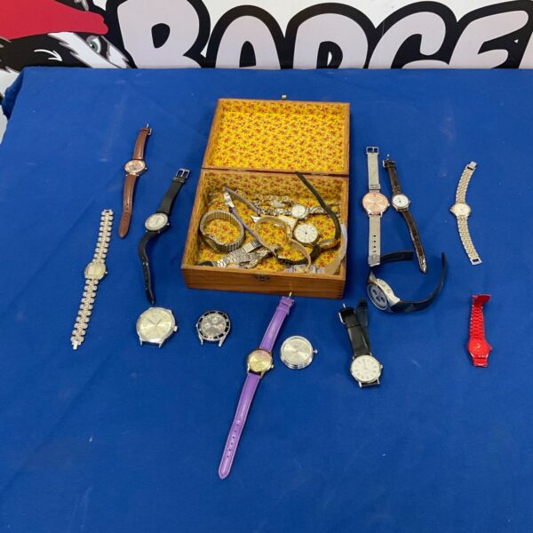 Full view of vintage watch lot with wooden box on blue background.