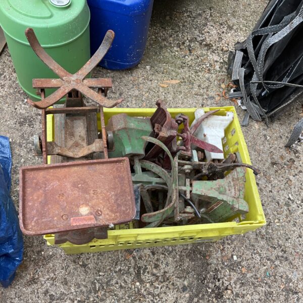 Crate of vintage weighing scales with rusted metal components.