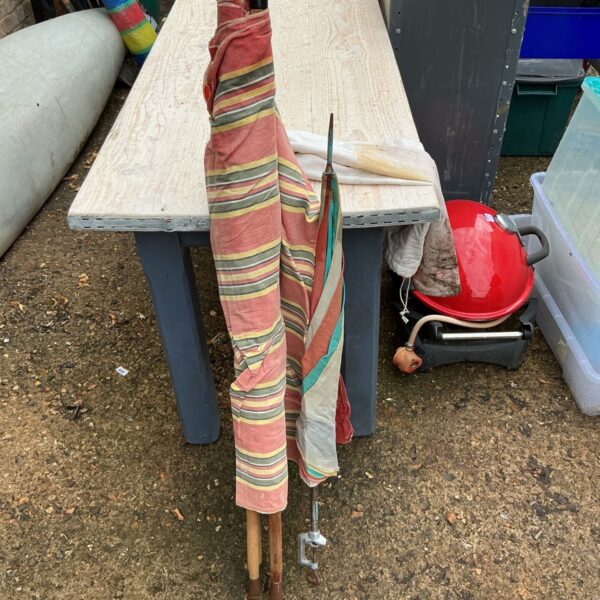 Colourful vintage windbreaker parasol with striped fabric.