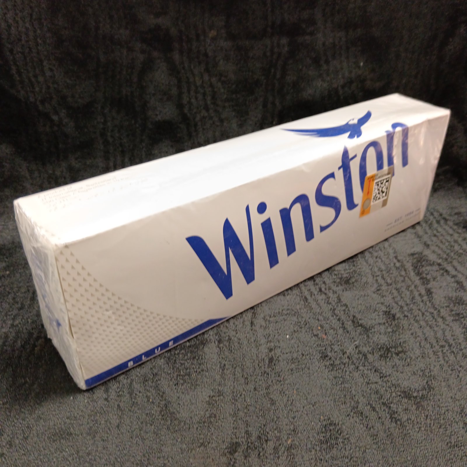 Sealed box of vintage Winston Blue cigarettes for collectors.