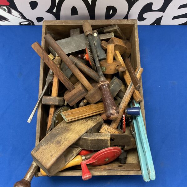 Vintage woodworking tools including planes and chisels in a wooden box.