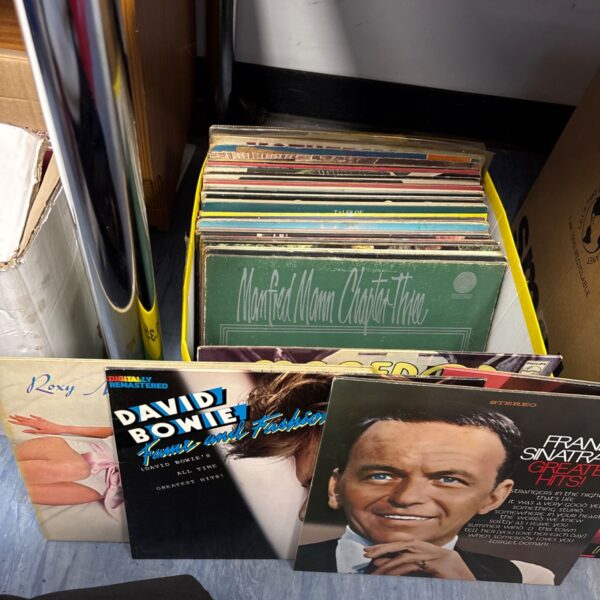 Mixed vinyl record collection including a David Bowie album.
