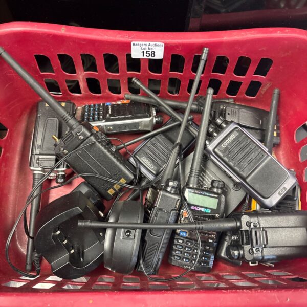 Lot of used walkie talkies including a Baofeng GT-3 radio.