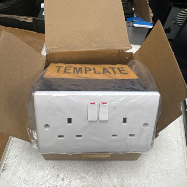 White wall mounted electrical socket with keyhole, UK plug socket.