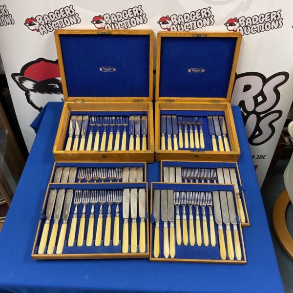 Vintage silver plated cutlery sets by Watherton & Son on display.