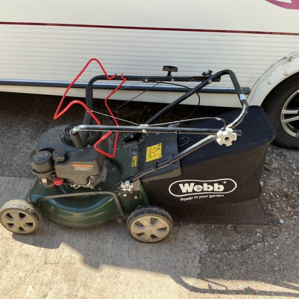 Used Webb Classic self propelled petrol lawnmower in garden setting.