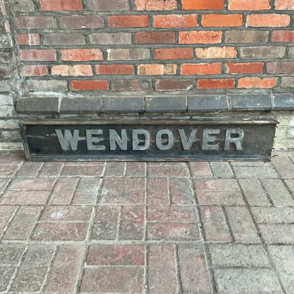 Antique Wendover train station sign with weathered enamel lettering.