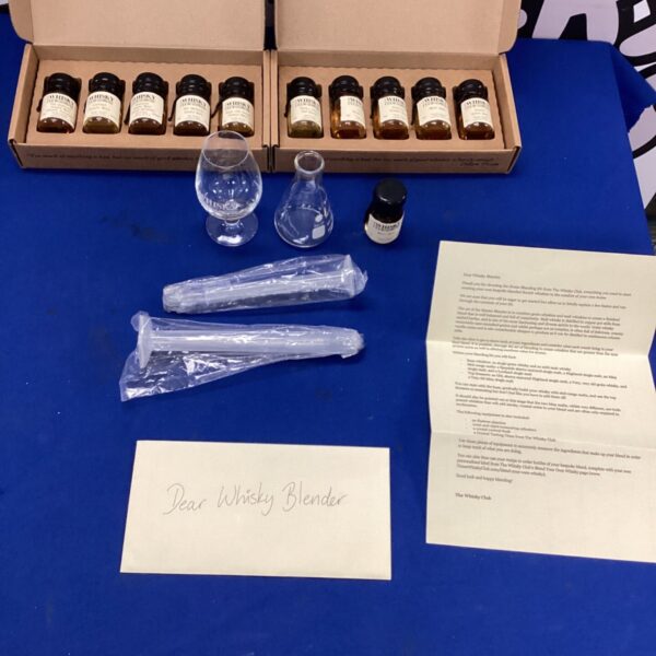 Whisky blending kit with multiple small bottles of single malt whisky.