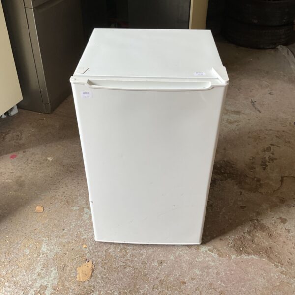 White compact fridge with a sticker on the door.
